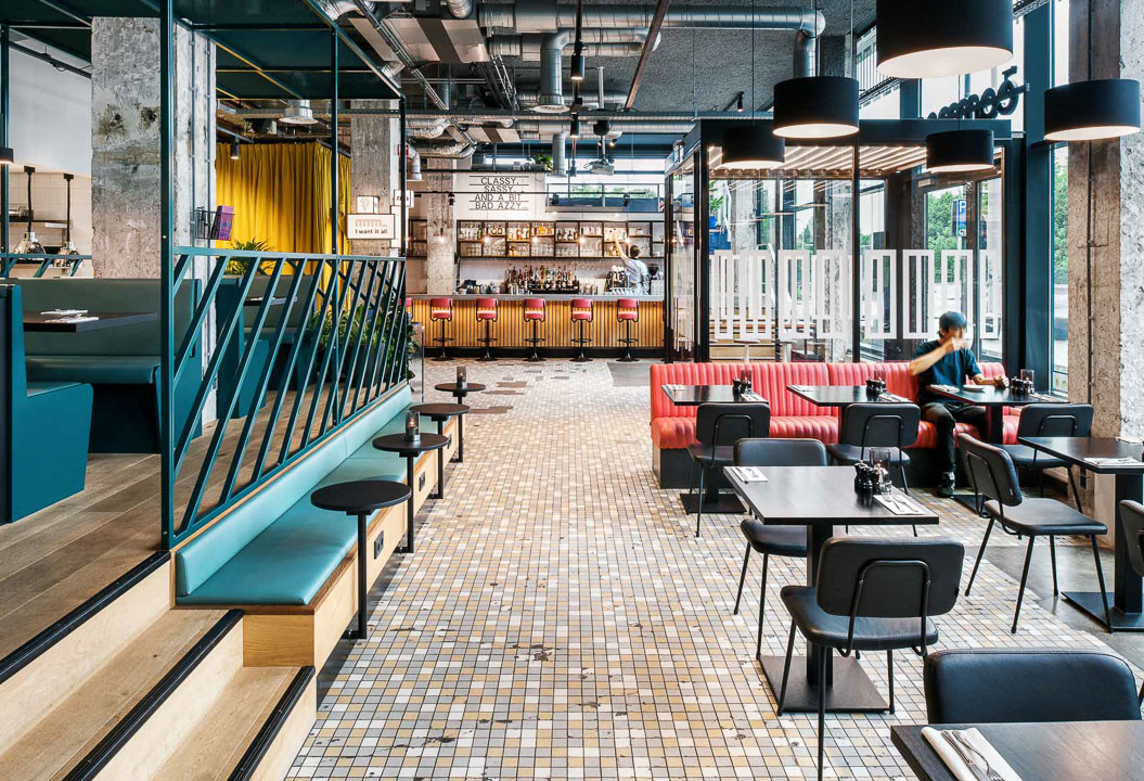 View of dining room and bar at the back at The Commons restaurant at The Social Hub Rotterdam