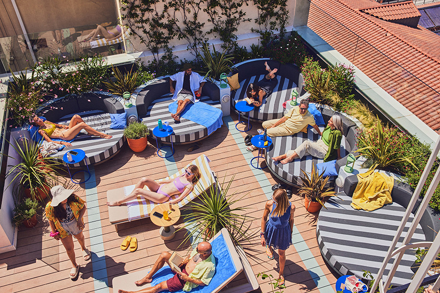 Guests sunbathing on the rooftop terrace of The Social Hub Madrid