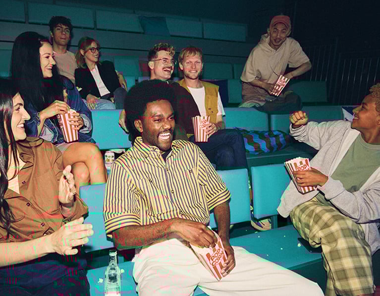 Guests watching a movie in a communal area at The Social Hub