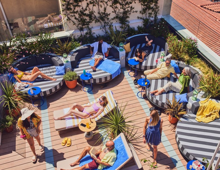 People sunbathing on the rooftop terrace of The Social Hub